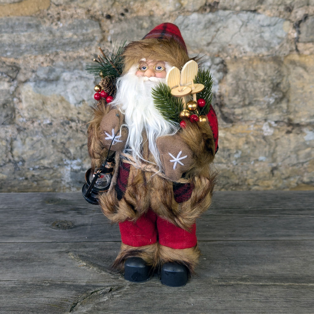 Santa red coat with check pattern carrying his Skis and a Lantern